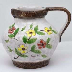 White and Brown Clay Pitcher with Red and Yellow Flowers